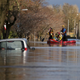 Rescue workers remove local residents by boat from a flooded residential street in Carlisle, Britain December 6, 2015. British police have declared a major incident in northern England after prolonged heavy rain caused widespread flooding and forced emergency services to evacuate residents from their homes. REUTERS/Phil Noble